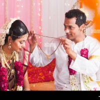 Bridegroom putting Mangal Sutra to a bride at the South Indian wedding ceremony Stock Photo