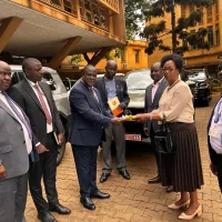 The Permanent Secretary of the Ministry of Public Service Mrs. Catherine Bitarakwate Musingwiire received three new vehicles this morning from the Deputy Secretary to the Treasury Mr. Patrick Ociliap at the Ministry