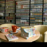 Duesseldorf Germany. 07th Oct 2014. Manga comic are pictured on a table in front of bookshelves filled with manga comics in a manga-cafe in Duesseldorf Germany 07 October 2014. The owner Tatsuhiro